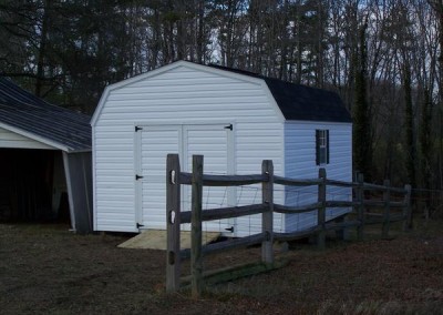 12 x 16 V-High Barn with white siding and trim, black shingles and shutters