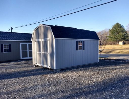 10 x 16 size painted high barn style shed with gap gray siding, white trim, black architectural shingle roof, black shutters, 8' ridge vent, ggs 6 foot doors, two windows.