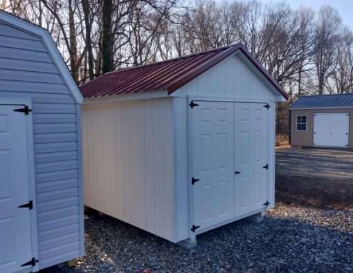 8 x 12 size painted classic style shed with white siding, white trim, rustic red metal roof, black shutters, fiber solid 6 foot doors, two windows.