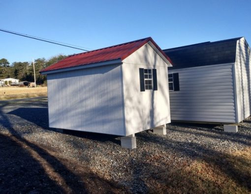 8 x 12 size painted classic style shed with white siding, white trim, rustic red metal roof, black shutters, fiber solid 6 foot doors, two windows.