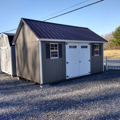 10 x 16 size painted garden style shed with clay siding, white trim, brown metal roof, brown shutters, fiber transom 6 foot doors and two windows.
