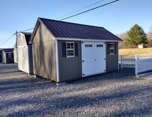 10 x 16 size painted garden style shed with clay siding, white trim, brown metal roof, brown shutters, fiber transom 6 foot doors and two windows.