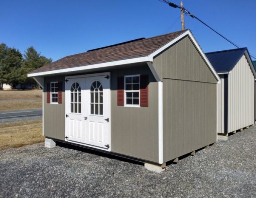 10 x 16 size painted carriage style shed with clay siding, white trim, brownwood architectural shingle roof, redwood shutters, 8' ridgevent, fiber top circle 6 foot doors, two windows.