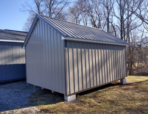 12x16 size metal garden style shed with white trim, taupe metal siding, charcoal metal roof, corners and j channel, 6 foot fiber doors with two windows.