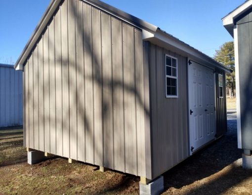 12x16 size metal garden style shed with white trim, taupe metal siding, charcoal metal roof, corners and j channel, 6 foot fiber doors with two windows.