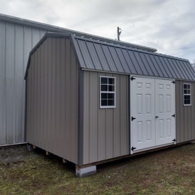10x16 size metal high barn style shed with white trim, taupe metal siding, charcoal metal roof, corners and j channel, 6 foot fiber doors with two windows.