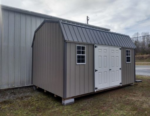 10x16 size metal high barn style shed with white trim, taupe metal siding, charcoal metal roof, corners and j channel, 6 foot fiber doors with two windows.