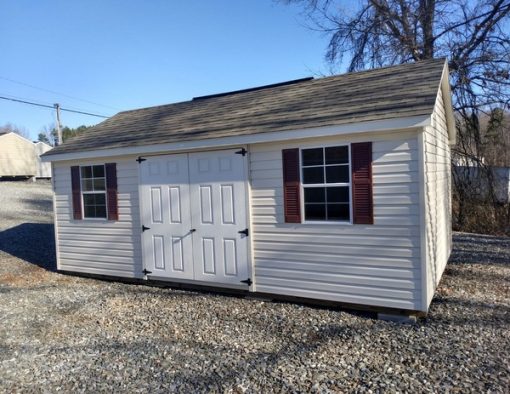 12x20 size vinyl classic roof style shed with pearl siding, pearl trim, driftwood architectural shingle roof, red shutters. Has 6 foot fiber doors and two windows.
