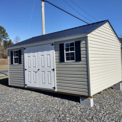 12x16 size vinyl a-roof roof style shed with olive siding, white trim, black metal roof, black shutters. Has 8' ridge vent, 6 foot fiber doors and two windows.