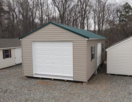 14 x 28 size vinyl a-roof garage style shed with clay siding, white trim, forest metal roof, green shutters, 9x7 garage door, 6 foot fiber 2 plank doors with two windows.