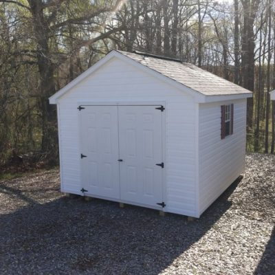 10x12 size vinyl classic roof style shed with white siding, white trim, black architectural shingle roof, maroon shutters. Has 6 foot fiber doors and two windows.