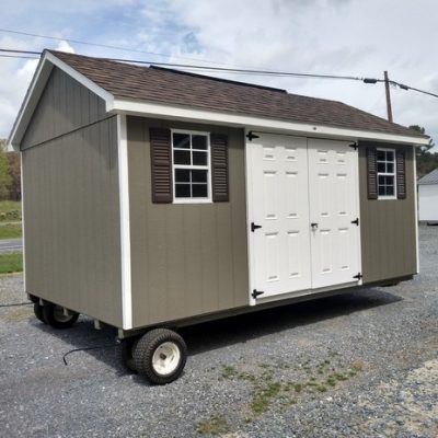 10 x 16 size painted classic style shed with clay siding, white trim, brownwood architectural shingle roof, brown shutters, 8' ridge vent, fiber 6 foot doors, two windows.