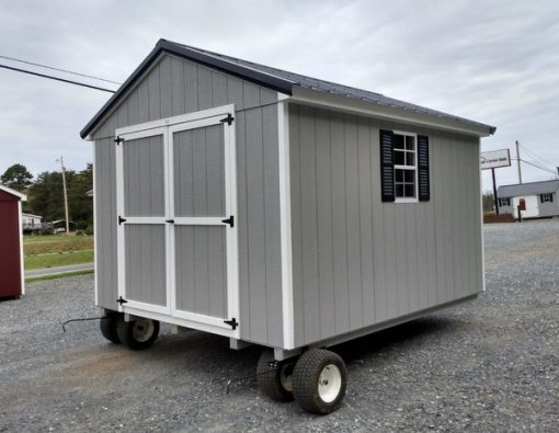 10 x 12 size painted a-roof style shed with gap gray siding, white trim, black metal roof, black shutters, ggs 6 foot doors, two windows.
