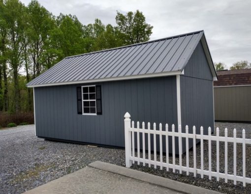 12 x 20 size painted garden style shed with gray siding, white trim, black metal roof, black shutters, ggs 6 foot doors and two windows.