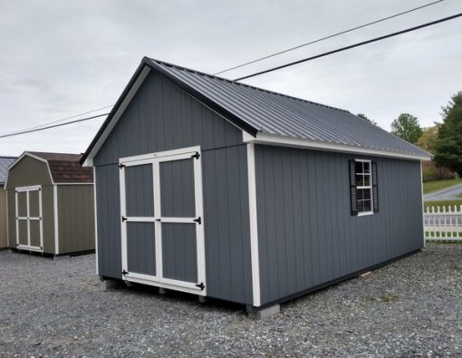 12 x 20 size painted garden style shed with gray siding, white trim, black metal roof, black shutters, ggs 6 foot doors and two windows.