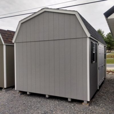10 x 16 size painted high barn style shed with gap gray siding, white trim, black architectural shingle roof, black shutters, 8' ridge vent, fiber 6 foot doors, two windows.