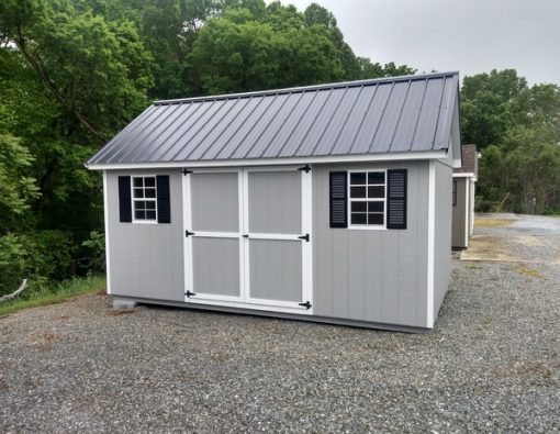 10 x 16 size painted garden style shed with gap gray siding, white trim, black metal roof, black shutters, ggs 6 foot doors, two windows.