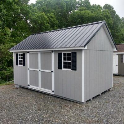 10 x 16 size painted garden style shed with gap gray siding, white trim, black metal roof, black shutters, ggs 6 foot doors, two windows.