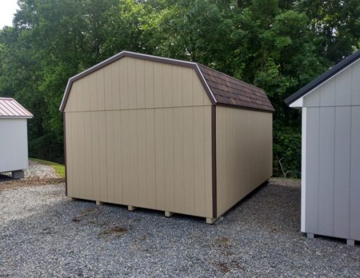 12 x 16 size painted high barn style shed with tan siding, brown trim, brownwood architectural shingle roof, brown shutters, 8' ridge vent, ggs 6 foot doors, two windows.
