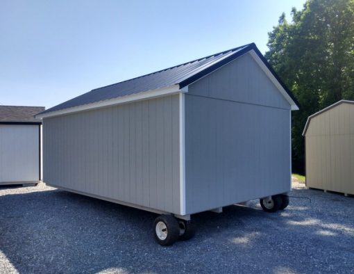 12 x 20 size painted classic style shed with gap gray siding, white trim, black metal roof, black shutters, fiber solid 6 foot shed doors and two windows.