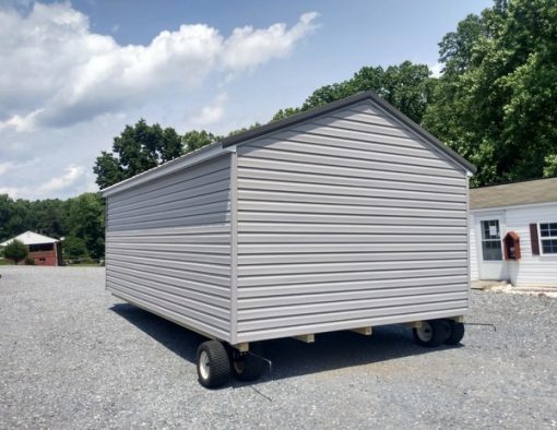 12x20 size vinyl a-roof roof style shed with flint siding, white trim, charcoal metal roof, black shutters. Has 6 foot fiber doors and two windows.