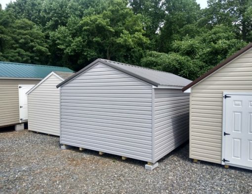 12x20 size vinyl a-roof roof style shed with flint siding, white trim, charcoal metal roof, black shutters. Has 6 foot fiber doors and two windows.