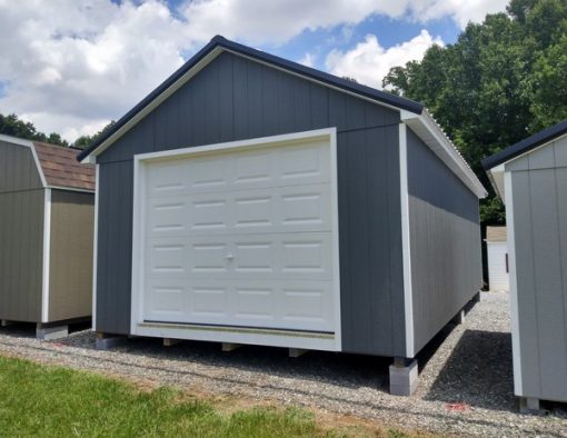 14 x 28 size painted classic garage style shed with gray siding, white trim, black metal roof, black shutters, garage door, ggs 6 foot double doors, two windows.