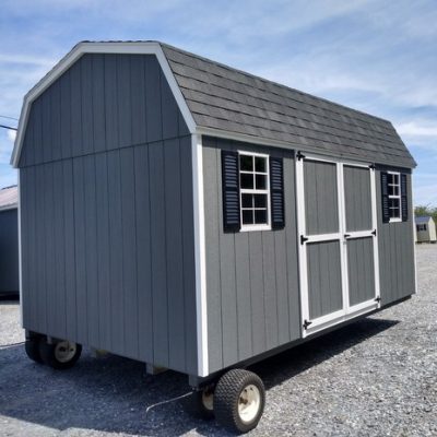 10 x 16 size painted high barn style shed with gray siding, white trim, black architectural shingle roof, black shutters, 8' ridgevent, ggs 6 foot doors, two windows.