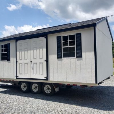 12 x 20 size painted a-roof style shed with barn white siding, black trim, black architectural shingle roof, black shutters, 8' ridgevent, fiber solid 6 foot shed doors, two windows.