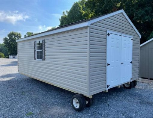 12x20 size vinyl a-roof roof style shed with clay siding, white trim, brownwood architectural shingle roof, brown shutters. has 8' ridge vent, 6 foot fiber doors and two windows.