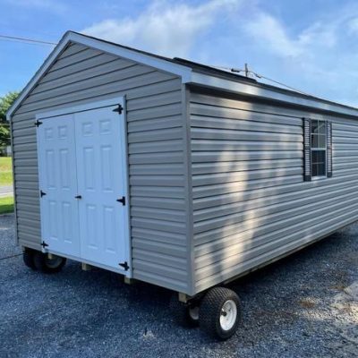 12x20 size vinyl a-roof roof style shed with clay siding, white trim, brownwood architectural shingle roof, brown shutters. has 8' ridge vent, 6 foot fiber doors and two windows.