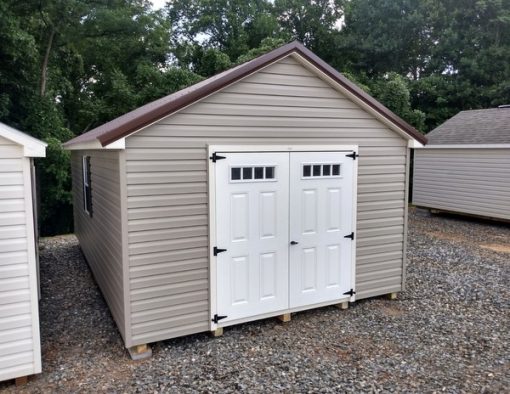 12x20 size vinyl classic roof style shed with clay siding, pearl trim, brown metal roof, brown shutters. Has 6 foot fiber transom shed doors and two windows.