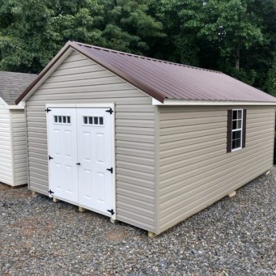12x20 size vinyl classic roof style shed with clay siding, pearl trim, brown metal roof, brown shutters. Has 6 foot fiber transom shed doors and two windows.