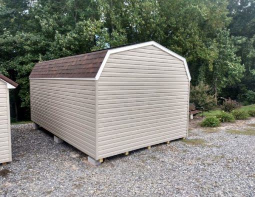 12x20 size vinyl high barn roof style shed with clay siding, white trim, brownwood architectural shingle roof, brown shutters. has 16' ridge vent, 6 foot fiber doors and two windows.