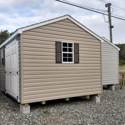 10x12 size vinyl a-roof roof style shed with clay siding, white trim, brownwood architectural shingle roof, brown shutters. has 8' ridge vent, 6 foot fiber doors and two windows.