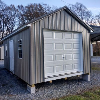 12x20 size metal classic garage style shed with white trim, taupe metal siding, charcoal metal roof, corners and j channel, 8x7 garage door, 3 foot fiber solid shed door with two windows.