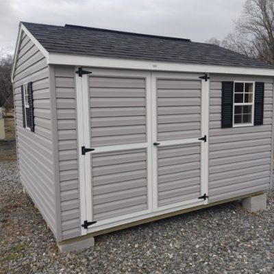10x12 size vinyl a-roof roof style shed with flint siding, white trim, black architectural shingle roof, black shutters. Has 8' ridgevent, 6 foot ggs doors and two windows.