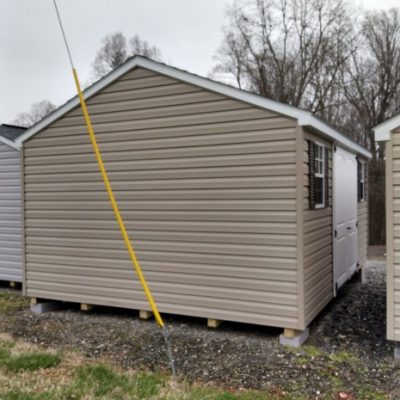 12x16 size vinyl a-roof roof style shed with clay siding, white trim, brownwood architectural shingle roof, brown shutters. has 8' ridge vent, 6 foot fiber 2 plank doors and two windows.