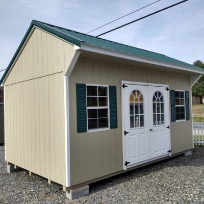 10 x 16 size painted carriage style shed with leola almond siding, white trim, forest metal roof, green shutters, 1' ft taller walls, fiber top circle 6 foot doors, two 24x36 windows