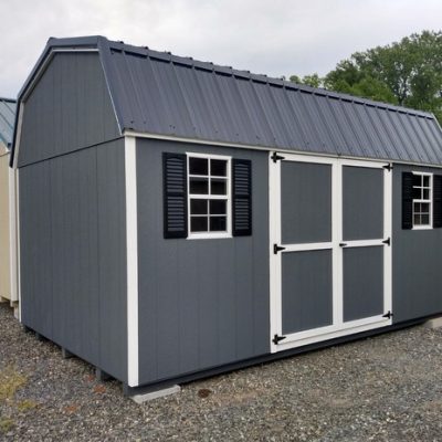 10 x 16 size painted high barn style shed with gray siding, white trim, black metal roof, black shutters, ggs 6 foot doors, two windows.