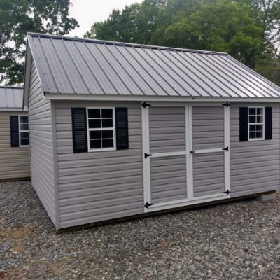 12 x 16 size vinyl garden style shed with flint siding, white trim, black metal roof, black shutters, ggs 6 foot doors, two windows.