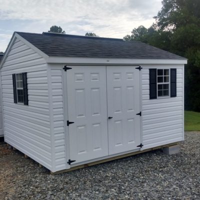 10x12 size vinyl a-roof roof style shed with white siding, white trim, black architectural shingle roof, black shutters. Has 8' ridgevent, 6 foot double doors and two windows.