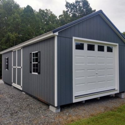 14 x 28 size painted classic garage style shed with gray siding, white trim, black metal roof, black shutters, garage door with glass, ggs 6 foot double doors 1' ft taller, two windows.