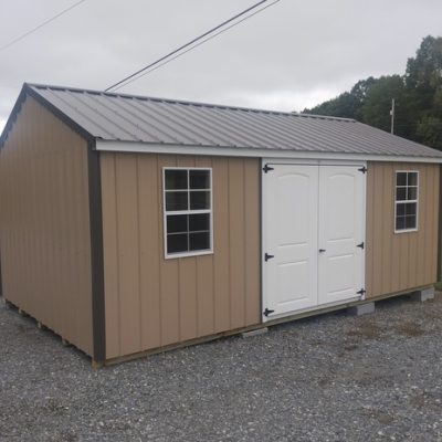 12x20 size metal a-roof style shed with white trim, tan metal siding, burnished slate metal roof, corners and j channel, 6 foot fiber 2 plank doors with two windows.