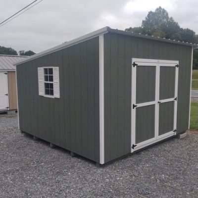 12x12 size painted economy style shed with avocado siding, white trim, alamo metal roof, white shutters, ggs 6 foot doors with two windows.
