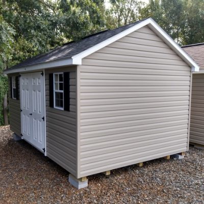 10x16 size vinyl classic roof style shed with clay siding, white trim, black architectural shingle roof, black shutters. Has ridgevent, 6 foot fiber doors and two windows.