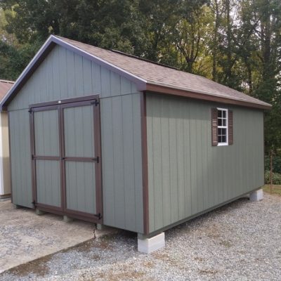 12 x 16 size painted classic style shed with avocado siding, brown trim, brownwood architectural shingle roof, brown shutters, 8' ridge vent, ggs 6 foot doors, two windows.