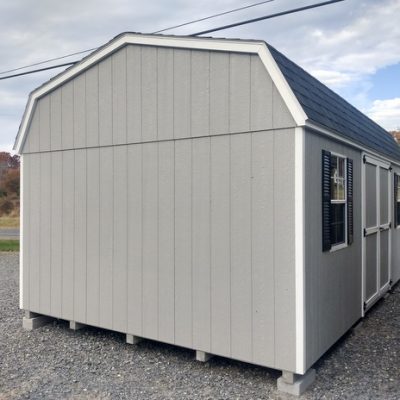 12 x 20 size painted high barn style shed with gap gray siding, white trim, black architectural shingle roof, black shutters, (2) 8' ridge vents, ggs 6 foot doors, two windows.