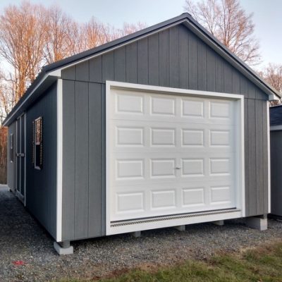 14 x 28 size painted classic garage style shed with gray siding, white trim, black metal roof, black shutters, garage door, ggs 6 foot double doors 1' ft taller, two windows.