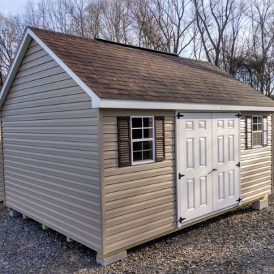 12x16 size vinyl garden roof style shed with clay siding, white trim, brownwood architectural shingle roof, brown shutters. has 8' ridge vent, 6 foot fiber doors and two windows.